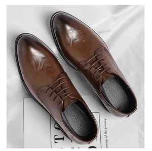 Top-down view of brown textured leather dress shoes for men in a business style