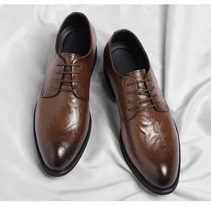 Detailed view of brown men's business leather shoes with unique hand-grabbed texture.