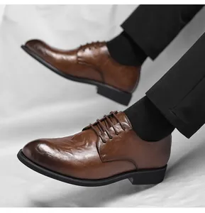 Detail view of men's brown vintage hand-scratched texture leather dress shoes