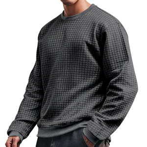 Detailed view of dark grey men's crew neck long sleeve knit shirt with small grid texture