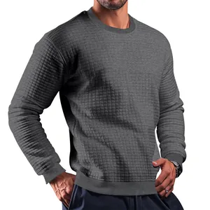 Close-up view of men's slim-fit long-sleeve t-shirt with grey square quilted texture