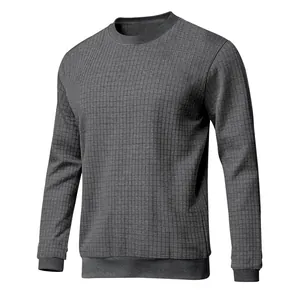 Detailed view of the gray small grid textured knit fabric on a men's long sleeve shirt.