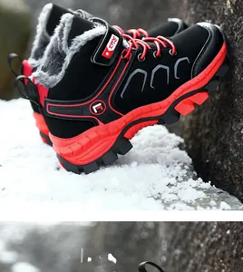Side detail of children's winter hiking boots with red laces and warm fur lining