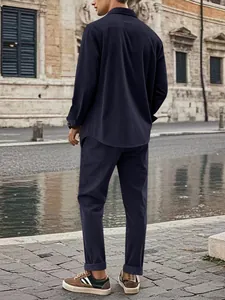 Rear view of a man wearing a navy blue corduroy casual shirt and trousers set outdoors