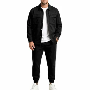 Full body view of man wearing black faux suede work jacket and joggers with white sneakers