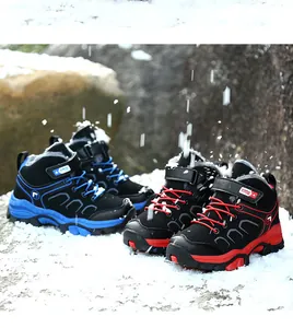 Durable kids' winter hiking boots with warm fleece lining and non-slip soles on snow.
