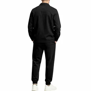 Back view of a man wearing a minimalist black suede jacket and matching jogger pants set
