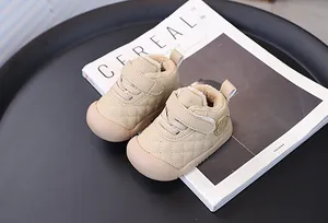 Close-up of beige quilted toddler shoes with warm fleece lining and Velcro strap