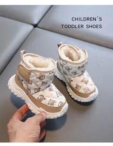 Close-up view of warm winter toddler snow boots with cute bear print and faux fur lining