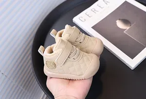 Detailed view of beige plush lined baby walking shoes with quilted pattern and velcro
