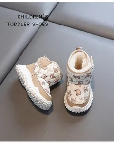 Close-up of warm winter toddler snow boots with cute bear pattern and plush lining