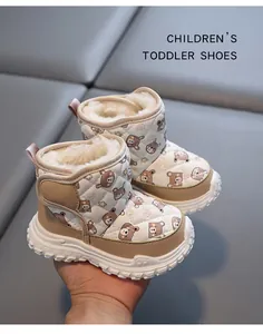Detail view of warm winter toddler snow boots with thick faux fur lining and bear pattern.