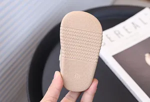 Close-up of the anti-slip textured rubber sole on toddler walking shoes for baby boys