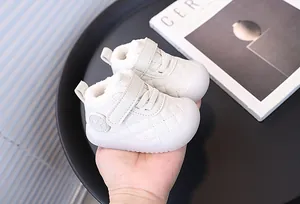 Close-up of white fleece-lined toddler walking shoes with quilted design