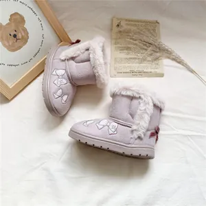 Detail of girls' mauve snow boots featuring embroidered bows and soft faux fur trim