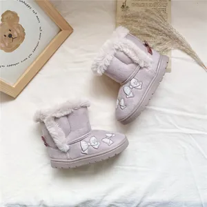Close-up of light purple girls' snow boots with faux fur trim and embroidered bows