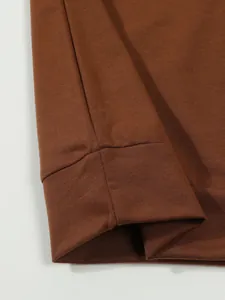 Close-up of the cuff stitching and fabric texture on a brown casual long-sleeve Polo shirt.