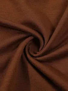 Close-up detail of high-quality dark brown soft knit fabric for autumn Polo shirts