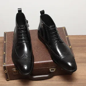 Side view of black leather brogue boots with intricate perforated wingtip detailing and zipper.
