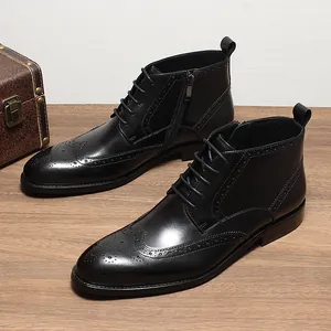 Detailed view of men's black leather brogue boots with side zippers and laces.