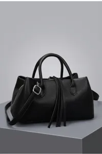 Black pebbled leather tote bag featuring elegant tassels and a versatile shoulder strap