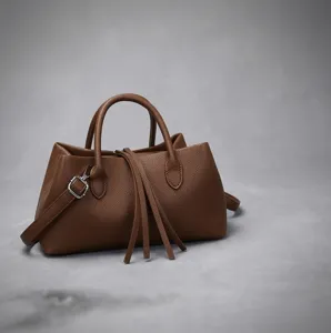 Elegant brown pebbled leather tote bag with fringe detail and detachable strap