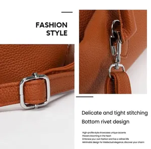 Close-up of fine stitching and silver hardware on brown pebbled leather tote bag