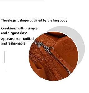 Close-up view of premium cognac pebbled leather texture and silver zipper details