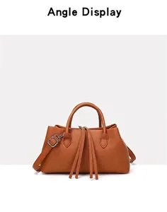 Detailed front view of a retro brown pebbled leather tote bag with tassels.