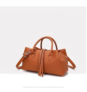 Elegant vintage brown pebbled leather tote bag featuring stylish tassel accents