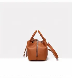 Elegant side view of a brown pebbled leather tote bag with a high-quality metal zipper detail