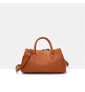 Front view of stylish brown faux leather tote bag with top handles and shoulder strap for women