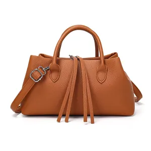 Vintage brown pebbled leather tote bag for women, featuring long tassels and top handles