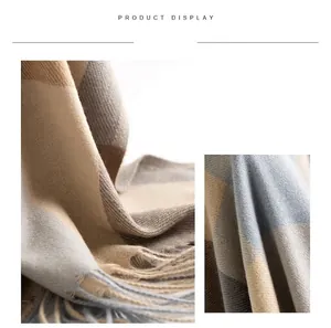 Close-up of soft plaid scarf texture with elegant tassels for extra winter warmth.