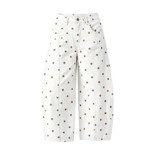 Detailed front view of white women's curved jeans with brown polka dots and loose fit