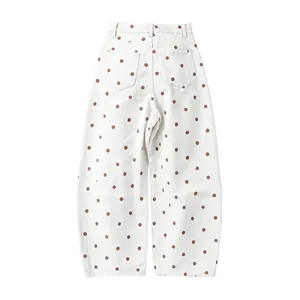Back view of women's white polka dot jeans featuring a loose barrel cut denim design