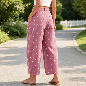 Rear view of pink wide-leg jeans with white polka dots in an outdoor park setting