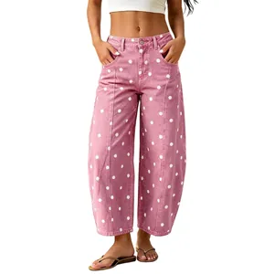 Close-up view of women's pink polka dot curved wide-leg jeans with a relaxed fit