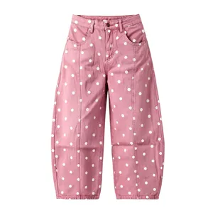 High-quality front view of pink denim pants featuring white polka dots and curved wide leg