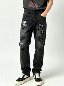 Black distressed straight-leg jeans for men with skull patches and heavy embroidery