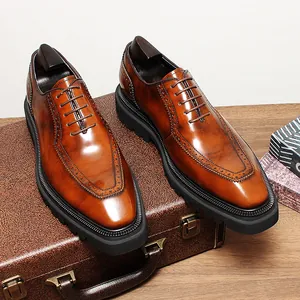 Close-up of brown glossy leather Oxford shoes showing fine brogue detailing and lug soles