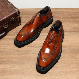 Detailed view of high-gloss brown leather Oxford shoes with classic brogue patterns