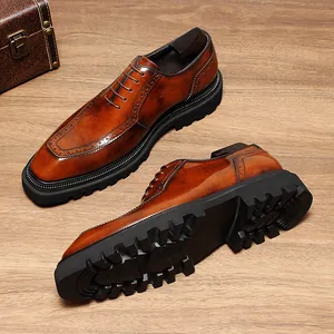Close-up of men's brown leather Oxford shoes with brogue detail and thick lug sole