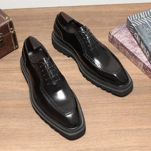 Premium high-gloss black leather Oxford shoes for men with thick soles on a wooden desk