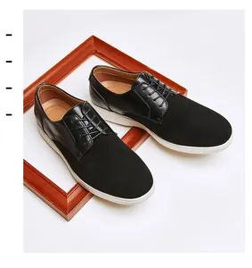 Macro view of black suede and smooth leather Derby shoes with white soles.
