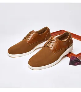 Close-up of men's brown suede and leather derby shoes with thick white soles.