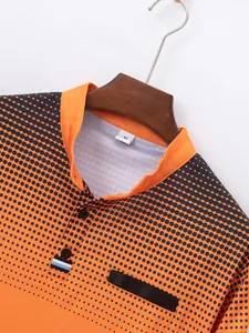 Close-up detail of men's orange long sleeve Polo shirt with black polka dot gradient print