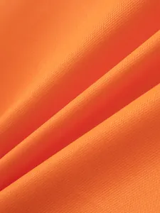 Macro detail shot of breathable orange piqué fabric for men's long-sleeve Polo shirt