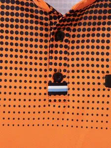 Close-up detail of men's polo shirt with orange halftone polka dot print and striped tab