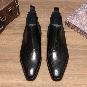 Vue de dessus de bottines Chelsea en cuir noir avec motif script gravé au laser